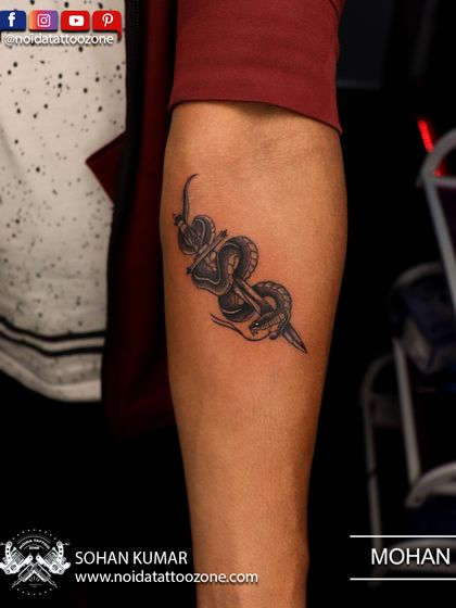 A snake wrapped around a dagger, a classic symbol of power and protection. This small but detailed tattoo was placed on the calf.
