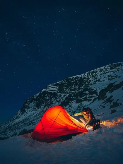 For the more adventurous soul, I plan trips to the high mountains. Here, a glowing tent offers a warm sanctuary under a sky full of stars, surrounded by the silent majesty of snow. This is an unforgettable winter camping experience.