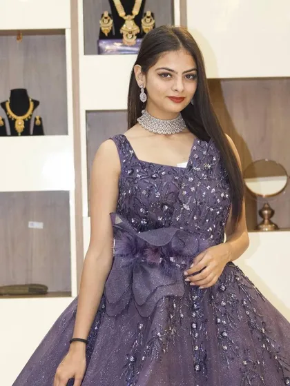 A closer look at the intricate beadwork and the unique design of this stunning purple gown.