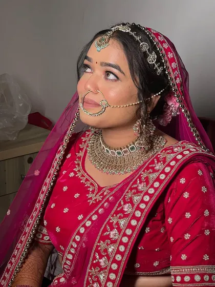 Looking up, this bride shows off her complete look, from the maang tikka to the intricate details of her lehenga. The makeup ties it all together.