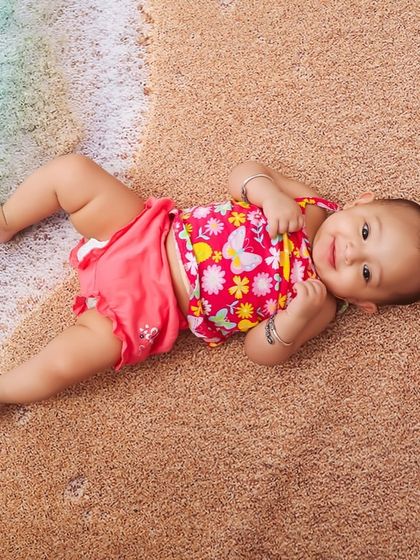 Lying on the "sand" by the "water's edge". I use different textures and angles to make my beach-themed studio sessions look and feel realistic and fun.