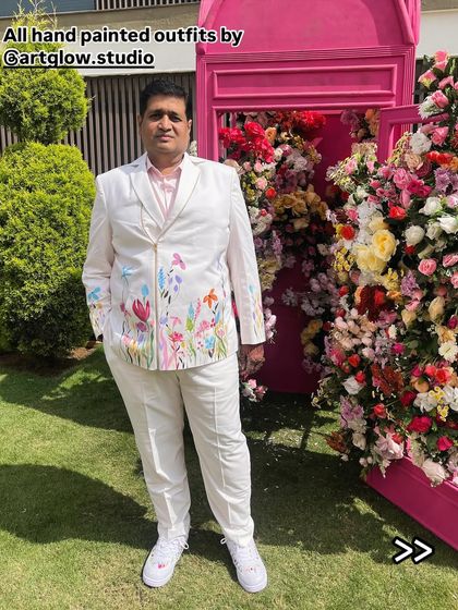 A client looking sharp in his custom-painted floral jacket. It brings me so much joy to see my clients wearing their stories with confidence and style at their special events.