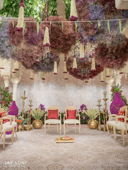 My passion is creating immersive floral installations that envelop you in beauty. This view of the "Garden of Vows" mandap shows how I layer textures and colors with hanging floral clouds and traditional mogra chandeliers to craft a truly enchanting experience.