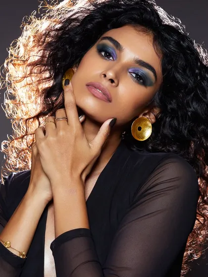 A glamorous look with a deep blue smokey eye and voluminous hair, perfect for an evening event or a fashion shoot.