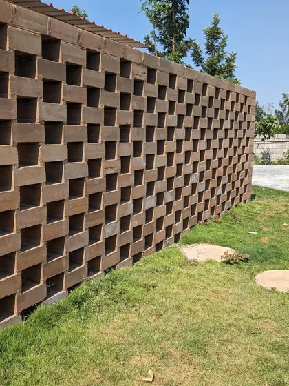 This unique perforated brick wall was constructed with bricks made on-site. It's an example of my commitment to sustainable hardscaping, creating custom structural elements that are both functional and aesthetically pleasing.