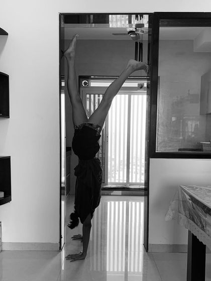 A moment of balance in Adho Mukha Vrksasana (Handstand). This inversion is a journey of building strength, overcoming fear, and finding a moment of stillness while upside down.