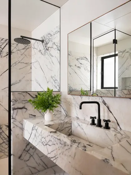 This master bathroom showcases my passion for using natural materials in a holistic way. I sculpted the vanity and sink from a single type of marble, creating a seamless, custom piece that is both a functional basin and a work of art.