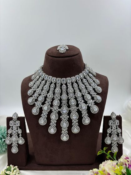 A magnificent, full-coverage AD necklace set designed for grand events. The intricate web of American Diamonds creates a dazzling effect, perfect for bridal and reception wear.