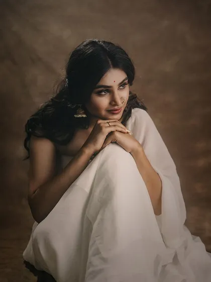 A duplicate of the seated portrait, capturing the full flow of the white saree and the model's elegant posture.