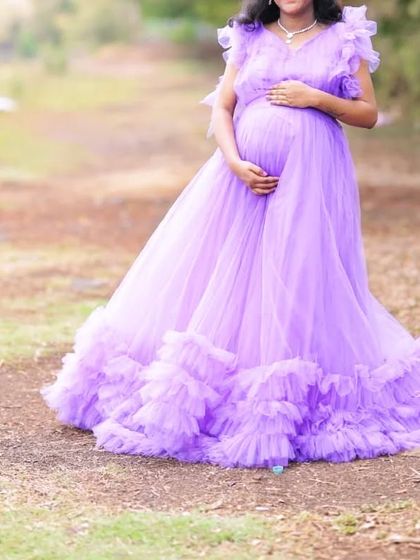 This dark lavender ruffle gown is a beautiful choice for a maternity or pre-wedding shoot, offering a soft and romantic feel.