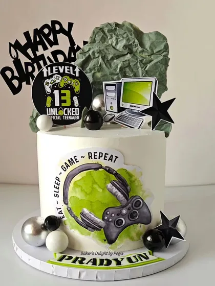 Level 13 unlocked! A cool gaming-themed cake for an official teenager, featuring a controller, headset, and computer monitor.
