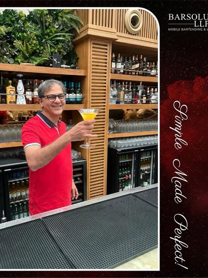 Another guest proudly displays his cocktail creation at the bar. Our events encourage creativity and hands-on participation.