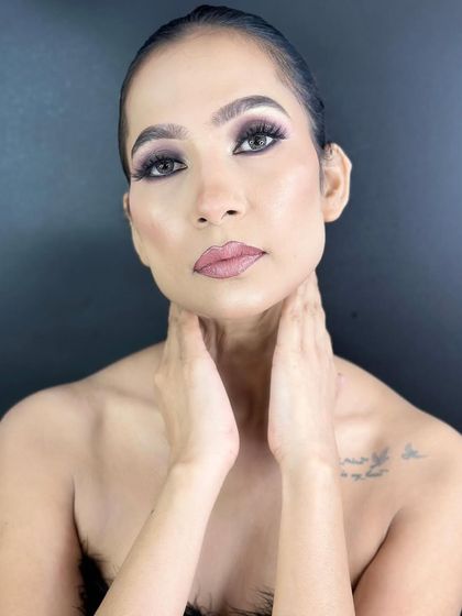 A portrait showcasing the flawless base and subtle contouring that complements the dramatic smokey eyes.