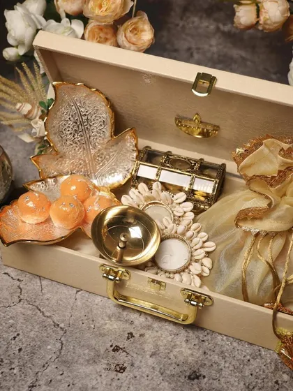 A wooden trunk filled with traditional Diwali items like diyas, sweets, and decorative pieces. Understanding cultural significance helps in creating more meaningful gifts.