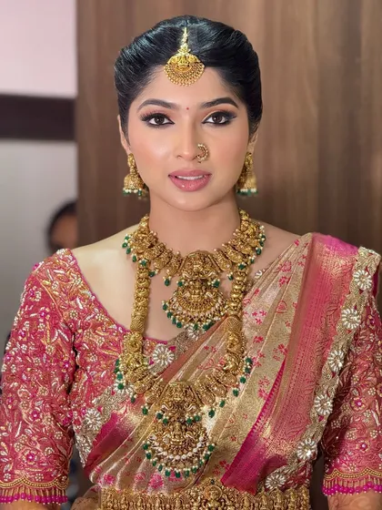 A beautiful portrait of the bride, showcasing her flawless skin and the intricate details of her temple jewelry. The makeup is natural yet defined.