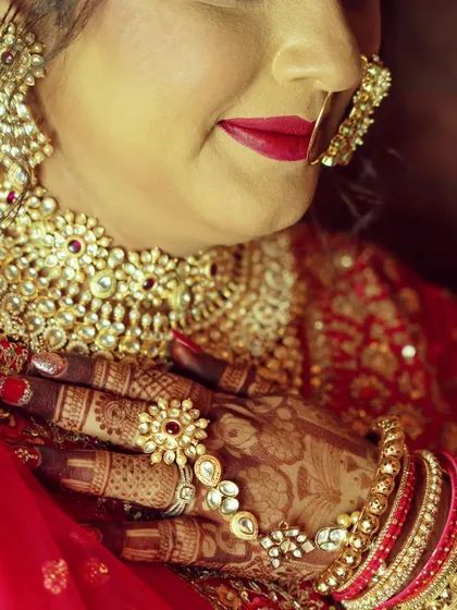 A detailed shot focusing on the bride's hands, highlighting the beautiful henna art and traditional wedding jewelry. I believe these small details are an essential part of your wedding story.