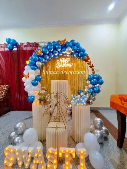 The complete blue, white, and silver butterfly-themed setup with personalized marquee letters spelling out "SWASTI".