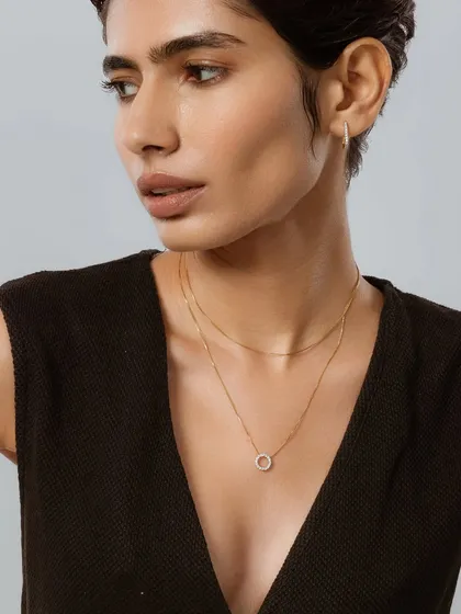A clean and minimal makeup look for a Guyal India jewellery shoot. The focus is on beautiful skin to ensure the delicate gold necklace remains the star of the shot.