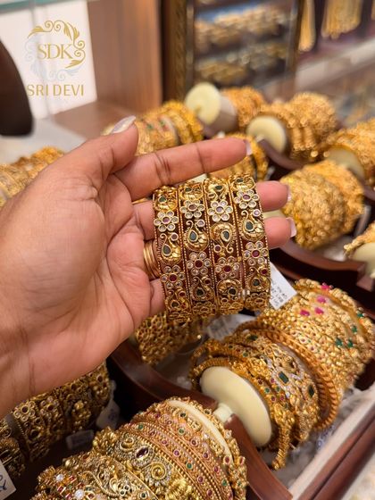These antique bangles feature a beautiful floral design with multi-colored stones. They are versatile and can be paired with many different traditional outfits.