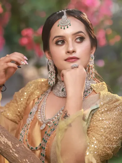 A collection of portraits featuring a model in a golden-hued traditional outfit, shot outdoors. The natural light and garden setting add a soft, ethereal quality to these elegant images.