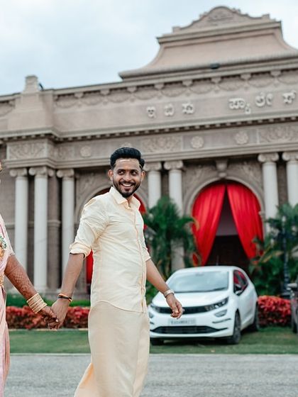 A beautiful portrait of a couple walking outside their wedding venue, capturing a quiet moment together.