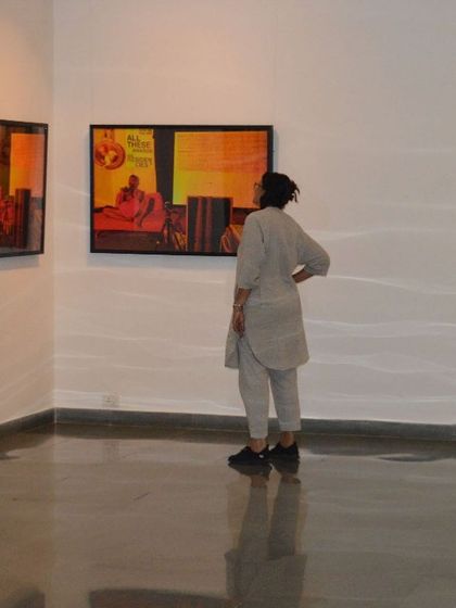 Pushpamala N. observing the works in Sandeep TK's show.