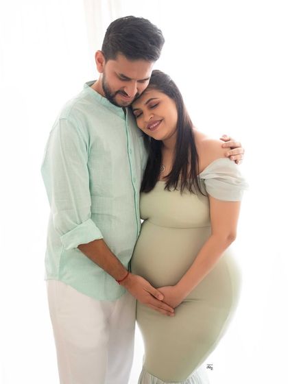 A tender embrace. This light and airy photo beautifully captures the affection and closeness of the couple as they await their little one.
