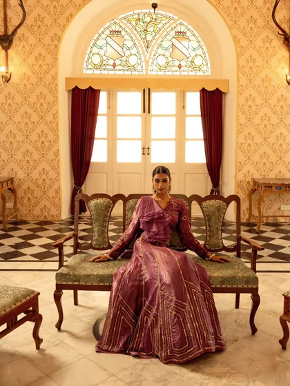 For this brand campaign, we chose a heritage palace to create a sense of timeless royalty. This wide shot was designed to showcase the grandeur of the location and the elegance of the couture gown, making the model appear regal and poised within a magnificent setting.