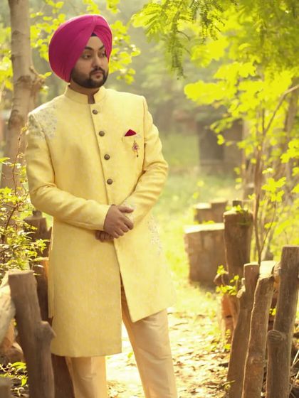 Another angle of our popular yellow sherwani, showcasing its elegant design against a natural backdrop. It's an ideal outfit for pre-wedding shoots or the main ceremony.