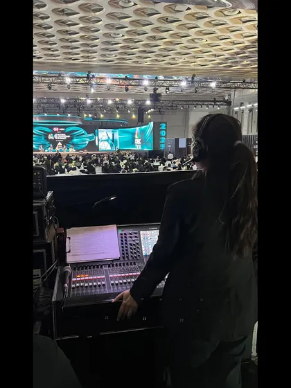 A team member at the audio console during the CNBC Global Leadership Summit. Managing audio for a large-scale broadcast event requires precision and expertise.
