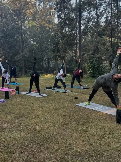 Our group practicing yoga in the park after a Sunday run. This is a regular part of our training schedule.