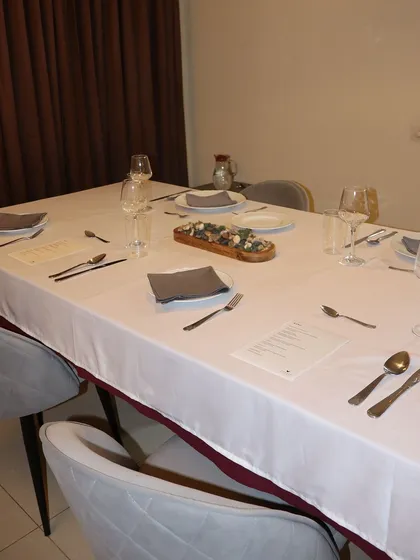 The full view of a beautifully set table for a private dinner at my residence. This is the chef's table experience I offer for those looking for an exclusive culinary event.