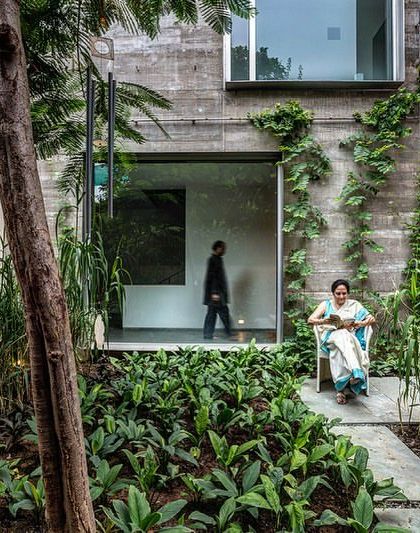 A lushly planted courtyard creates a tranquil green oasis. The space provides a quiet retreat and a visual amenity for the surrounding rooms, integrating the building with a verdant landscape.