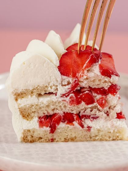 The perfect forkful of our strawberry and fresh cream cake, showing the balance of soft sponge, light cream, and fruit in every bite.