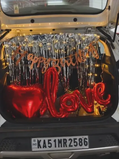 Another angle of the car boot surprise, showcasing the 'LOVE' balloon and the warm glow of the fairy lights. A perfect way to make someone feel special.