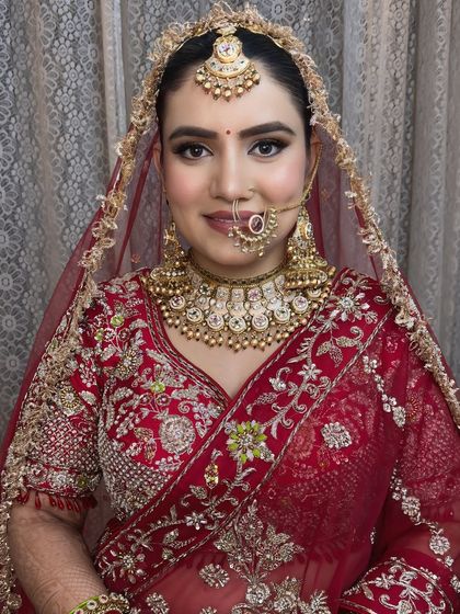 A classic bridal portrait. The makeup is timeless, with a focus on clean lines and a flawless complexion.