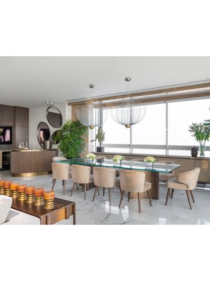 A wider view of the dining and bar area, showing how the space is designed for seamless entertaining. The open layout allows for easy flow between the living room, dining table, and bar, making it perfect for hosting guests.