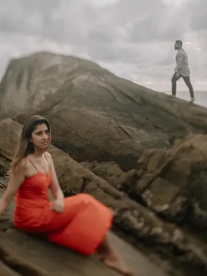 An artistic shot with Komal in the foreground and Harman in the background, using a shallow depth of field to create a dreamy, story-driven image.