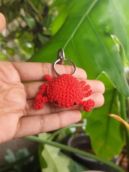 This is the crab design as a keychain. It's a sturdy and fun accessory that adds a pop of color to your belongings.