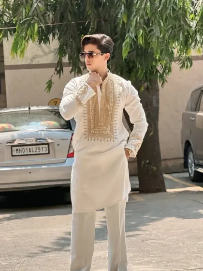 The model looking sharp in the white and gold kurta.