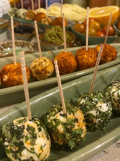 A closer look at our mini cream cheese rolls, seasoned with Paprika Garlic and Parsley Walnut. Each one is a perfect bite-sized appetizer, ideal for mingling and sharing at parties.