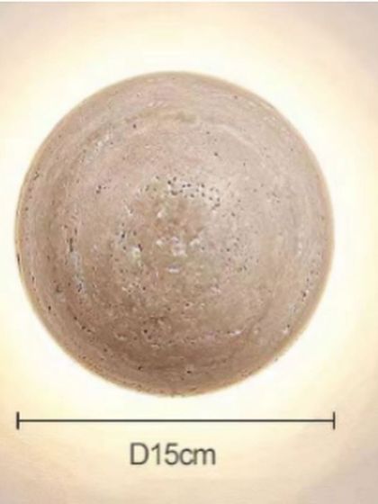 A spherical wall light made from travertine stone. The 15cm diameter makes it a perfect accent light, with a warm glow that highlights the stone's texture.