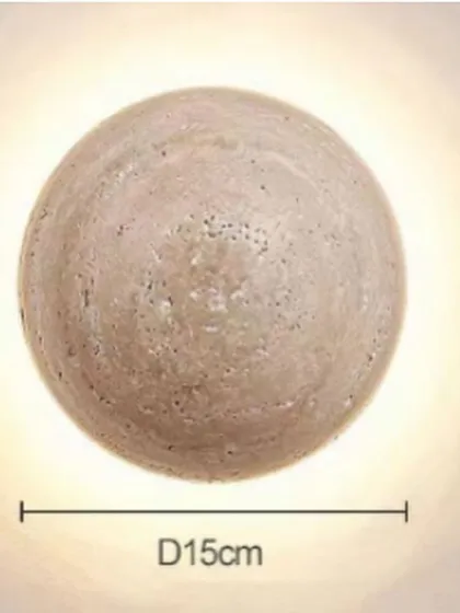 A spherical wall light made from travertine stone. The 15cm diameter makes it a perfect accent light, with a warm glow that highlights the stone's texture.