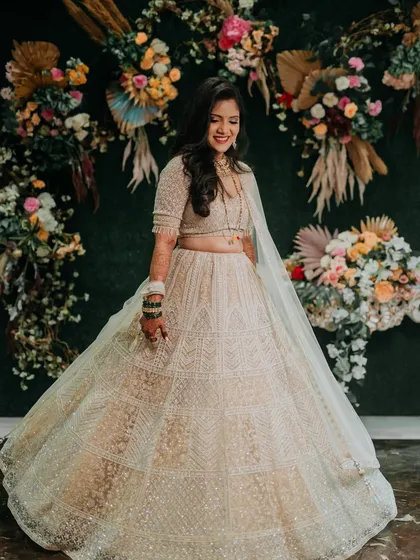 Sejal twirling in her gorgeous reception lehenga. The movement shows the beautiful flow of the outfit and her joyful spirit.
