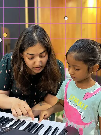 One on one guidance is key to building confidence. Here, one of our mentors works with a young pianist, making sure she understands the notes and feels comfortable at the keyboard. We believe in patient, personalized teaching for every child.