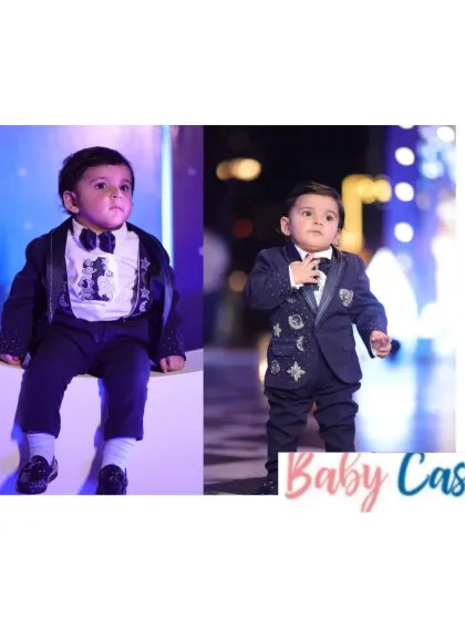 A little star ready for the spotlight. This custom navy blue tuxedo with intricate embroidery is perfect for a formal event or a wedding, making your little boy look and feel like a superstar.