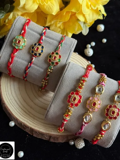 A beautiful collection of single rakhis featuring colorful floral kundan work. Each piece is unique, with vibrant enamel and stone details on a hand-braided thread.