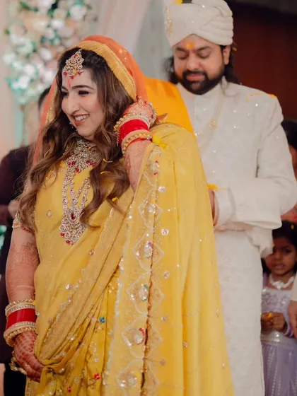 Capturing the joy of this bride's wedding ceremony. Her makeup is traditional and radiant, with warm tones and defined eyes, paired with soft waves for a look that is both classic and effortlessly beautiful.