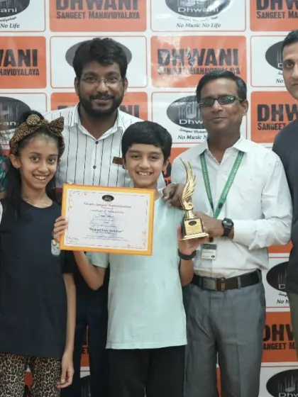 A beautiful family moment celebrating their children's success with our teachers. Our classes often feel like family fitness sessions, creating a welcoming space for everyone to grow together.