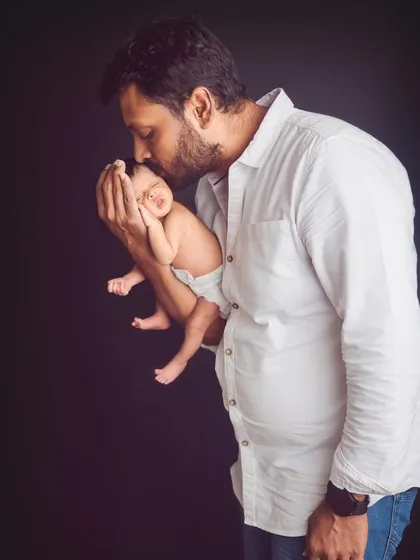 A father's gentle hands holding his brand new baby. These are the quiet, powerful moments we aim to preserve forever, showing the profound love that fills the room.